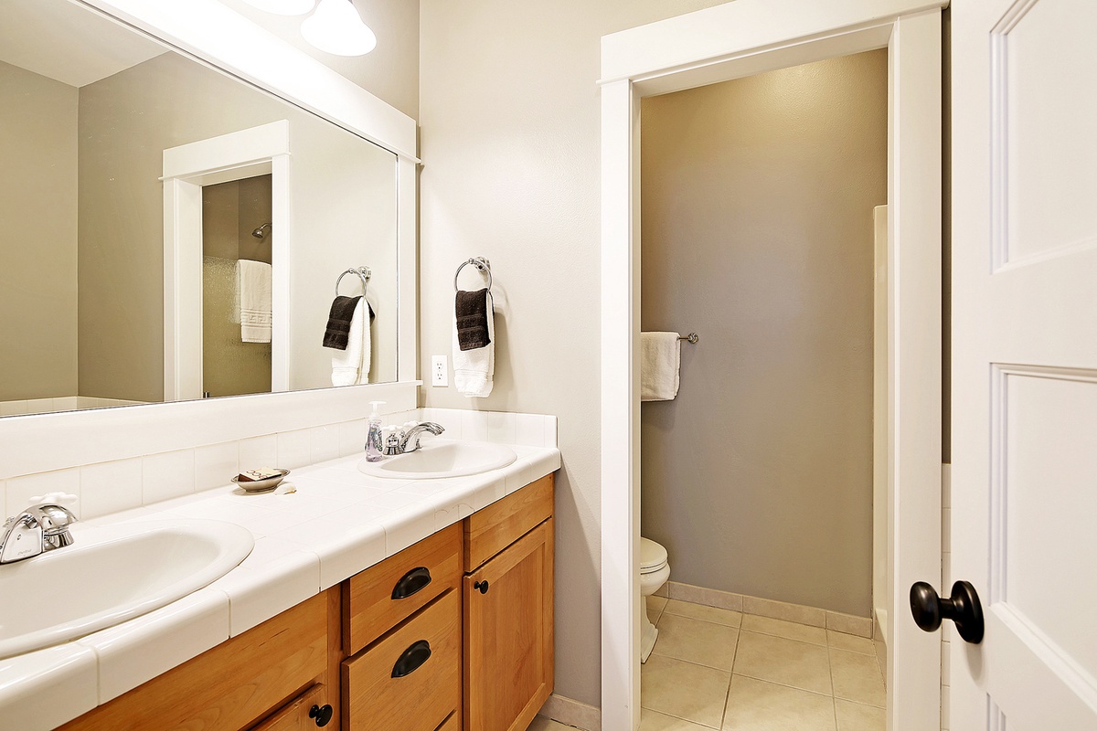 Main floor primary bathroom with tub and walk in shower