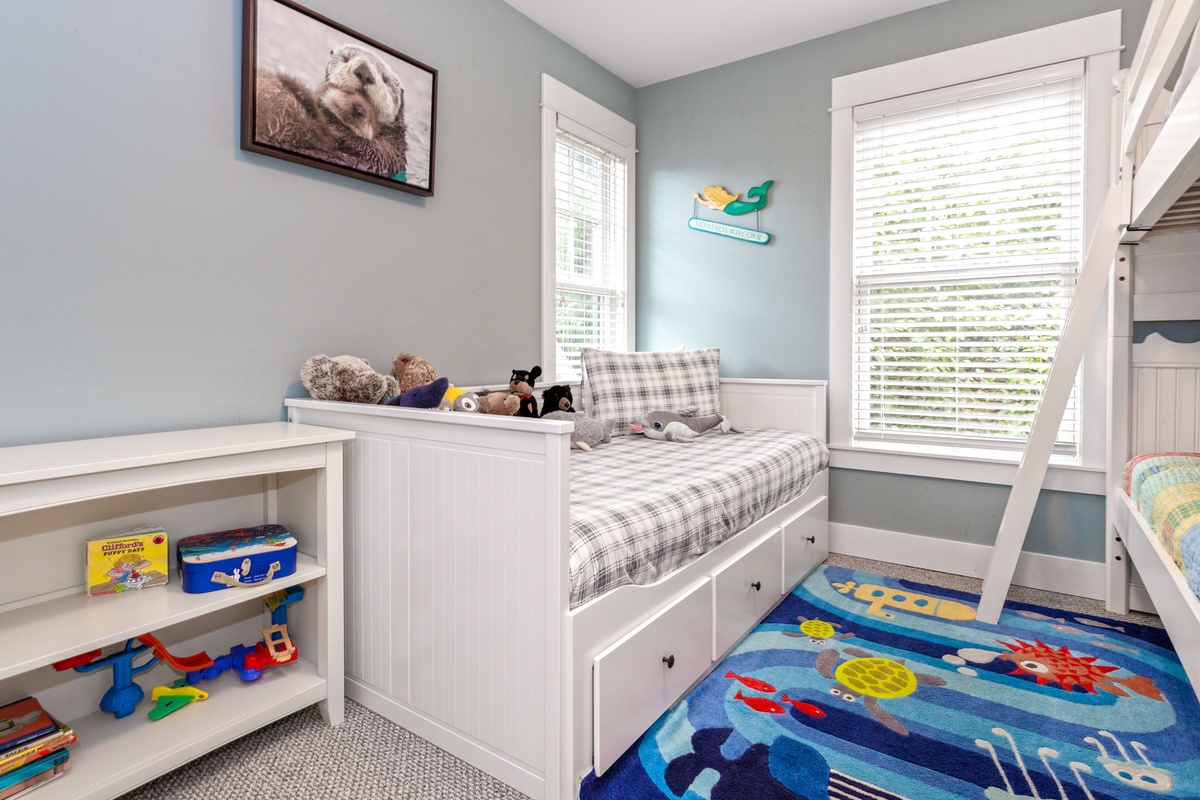 Cozy trundle bed in bunk room is perfect for kids