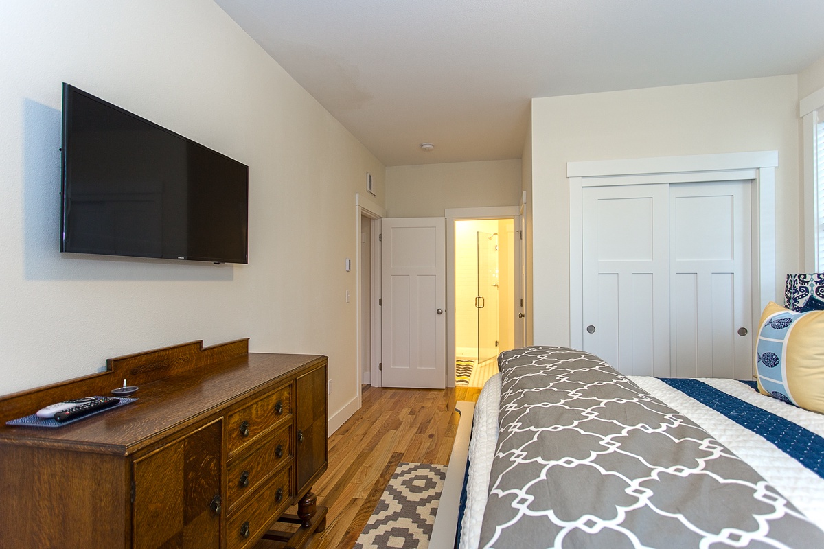 Main floor primary bedroom with tv