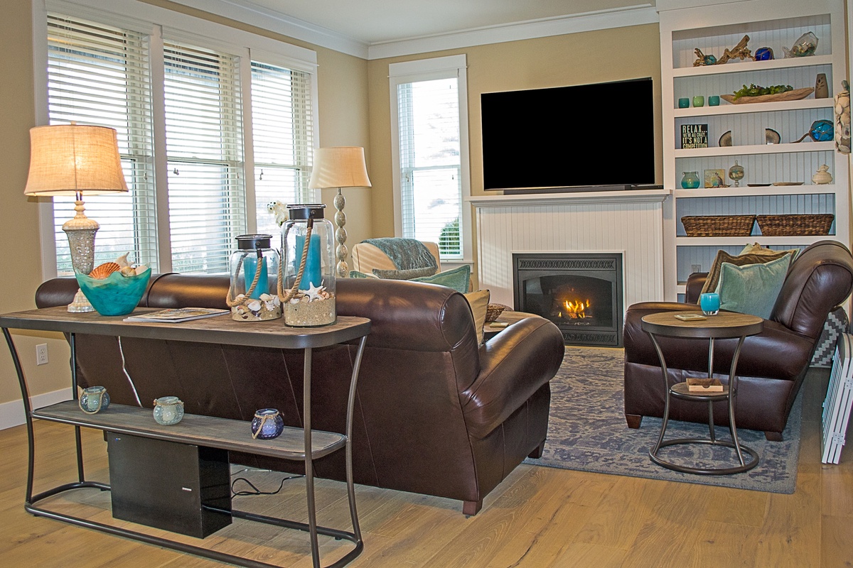 Living room with fireplace, tv, and ocean views