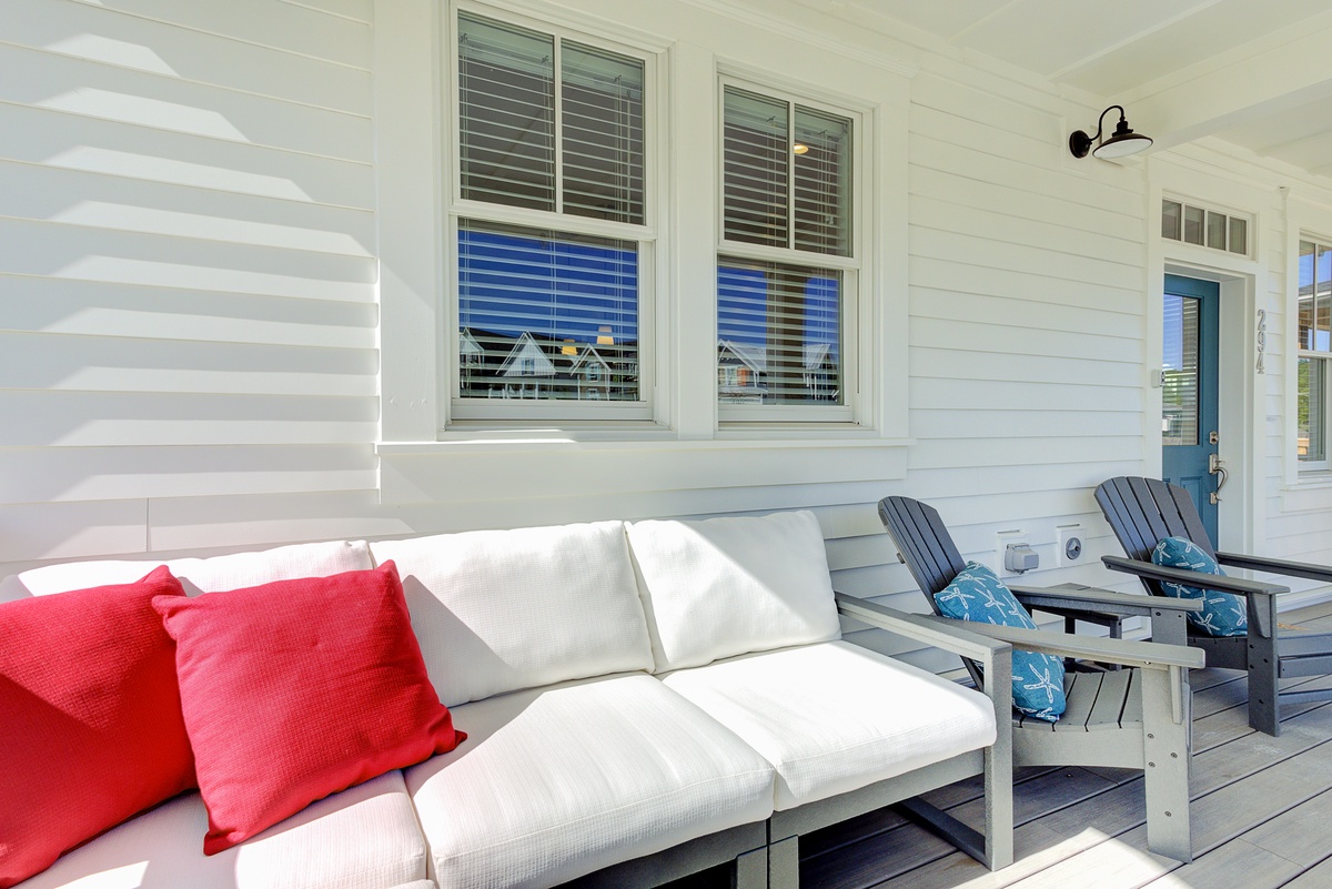 Covered front porch has lots of seating