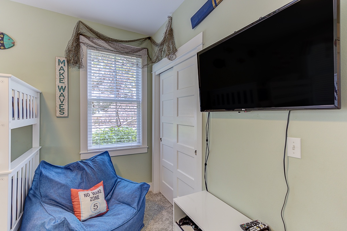 The bunkroom has a smart TV and old school Sega gaming system plus a comfy chair and a large closet too