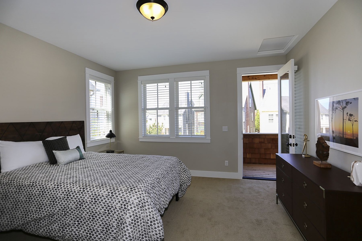 Second floor queen primary bedroom with in-suite five piece bathroom and access to the balcony