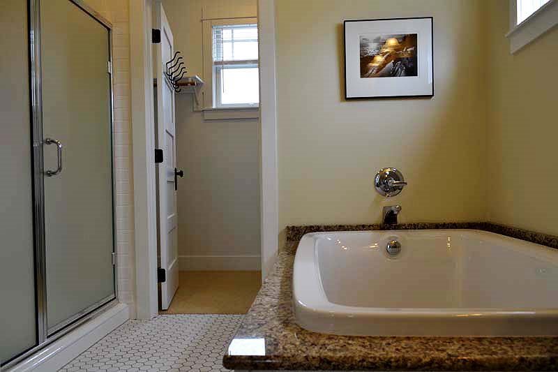 Primary ensuite bath with soaking tub, walk-in shower, walk-in closet