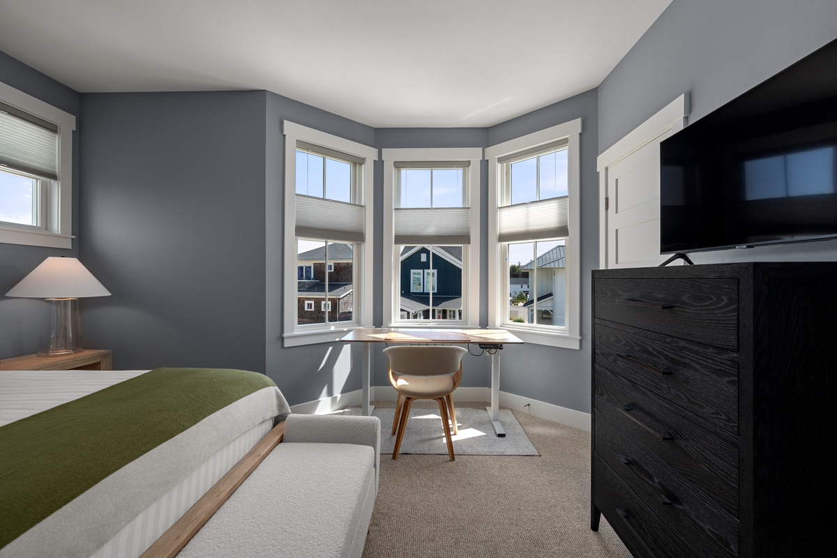 Electric stand-up desk in the queen bedroom