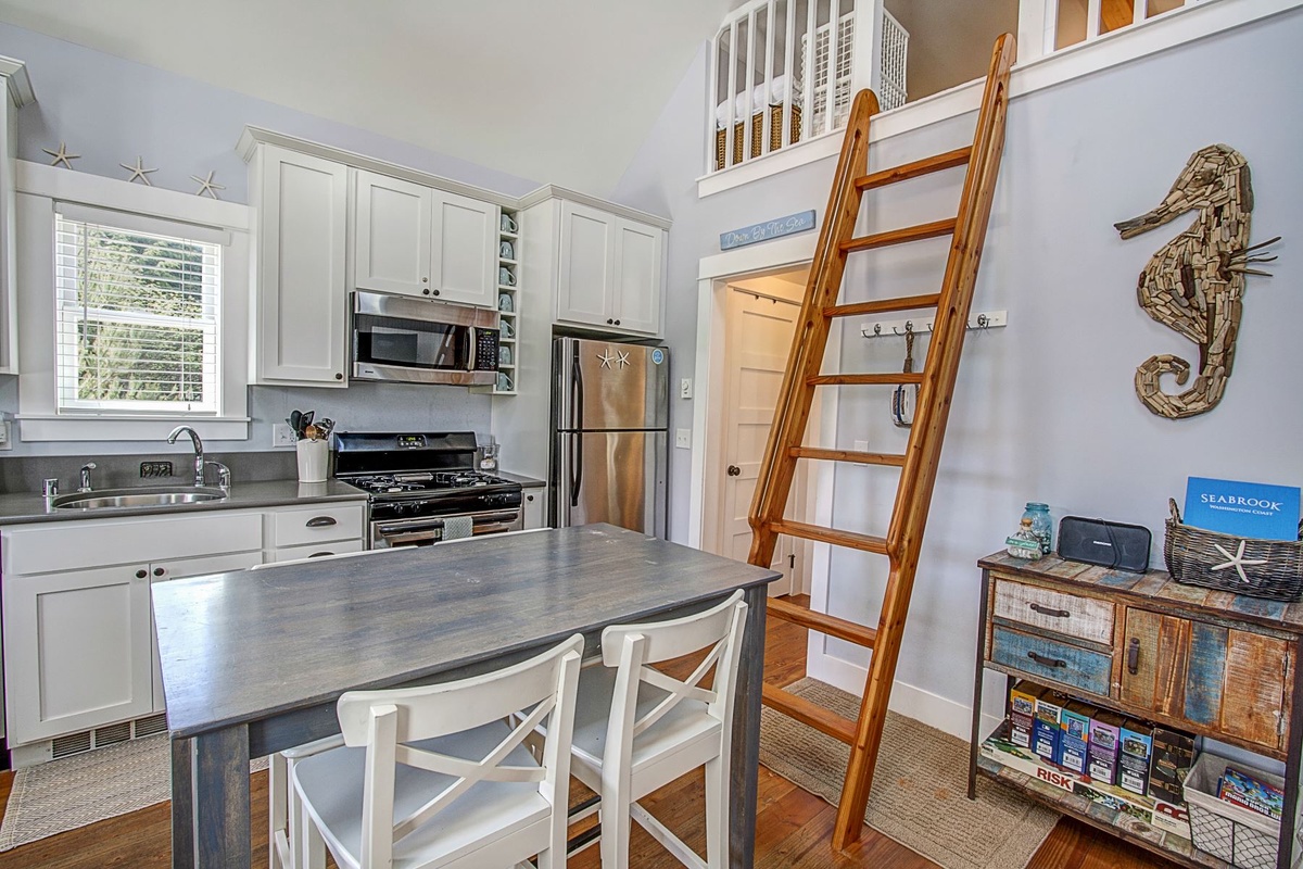 Dining table, kitchen, and ladder to loft