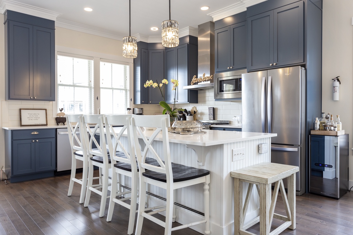 Modern kitchen with a 6-burner gas stove and wine fridge