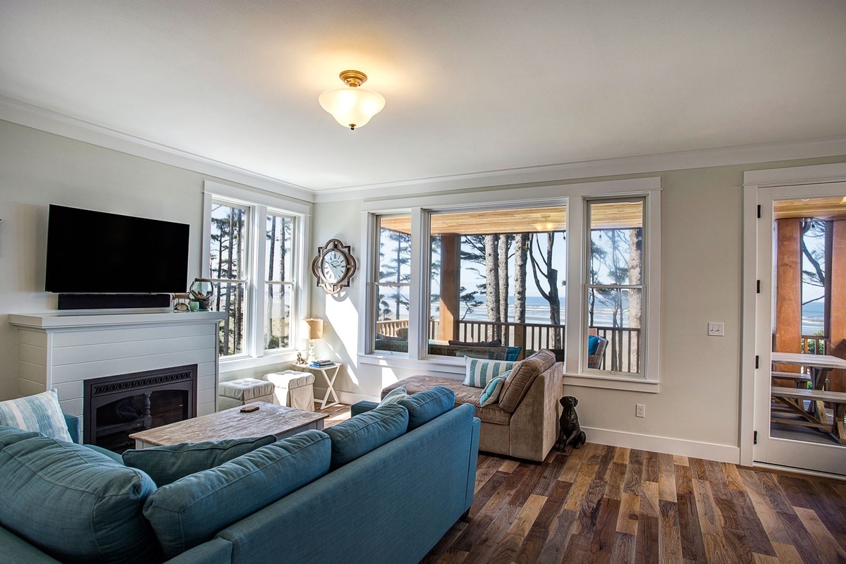 Living room with ocean view, gas fireplace, and flat screen TV