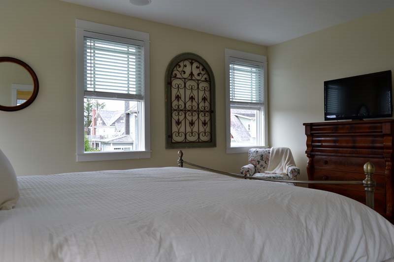 The cozy primary bed is designed for ultimate relaxation