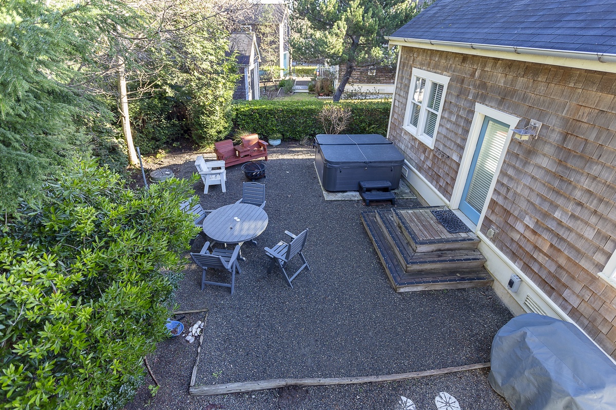 Backyard complete with firepit and hot tub