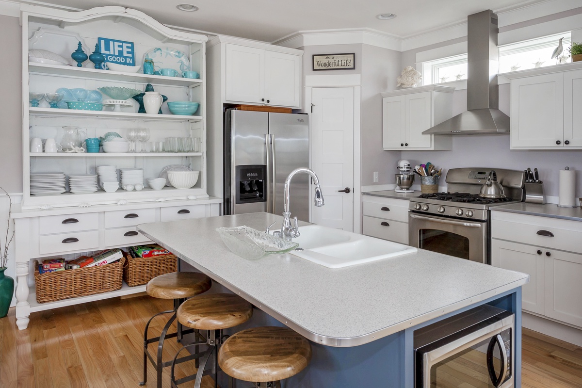 Stainless steel appliances, a wide range of beautiful porcelain dinnerware, wine glasses, serving dishes and even a snow cone machine and Panini maker!