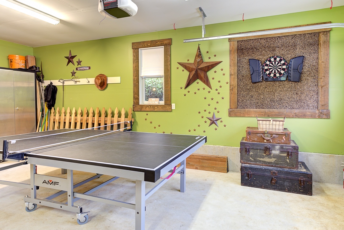 garage with ping pong table and dart board