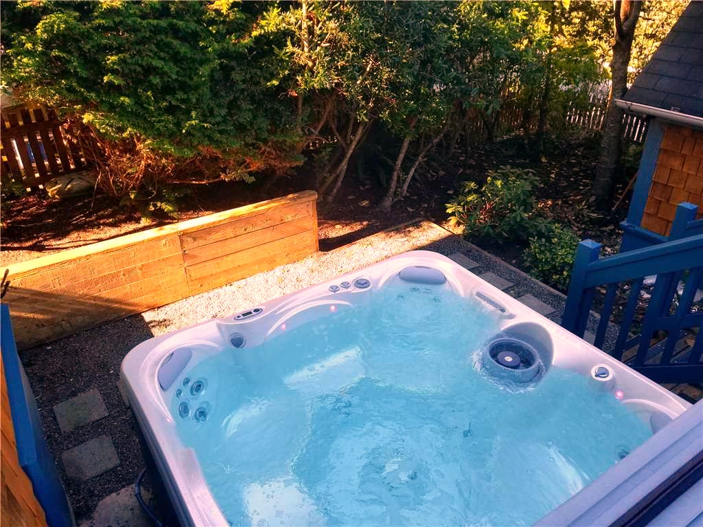 Extremely private and relaxing hot tub off backyard deck with lots of beach toys in storage bin