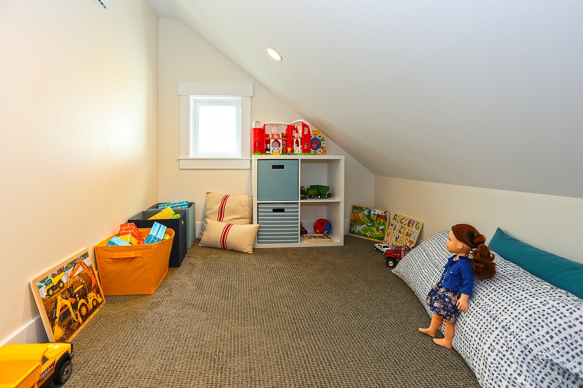 Carpeted playroom for children of all ages to explore the toys, books, puzzles, puppets and blocks that are provided