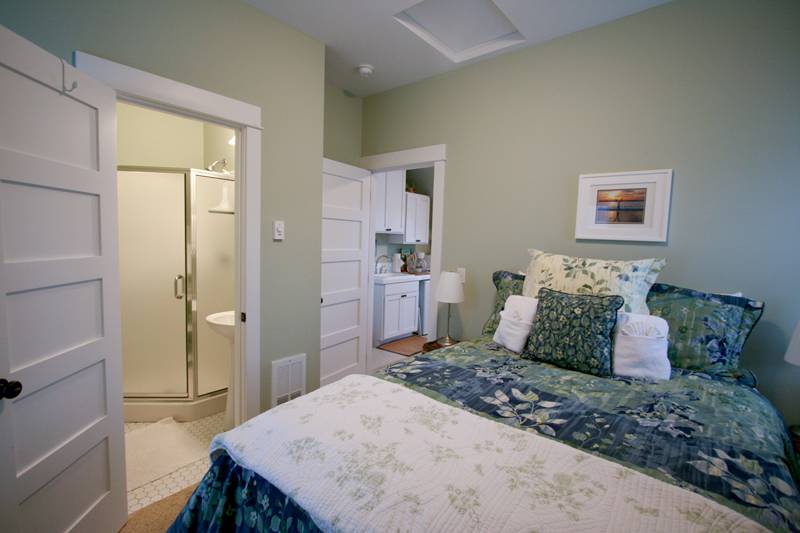 Carriage house bedroom with double bed and bath
