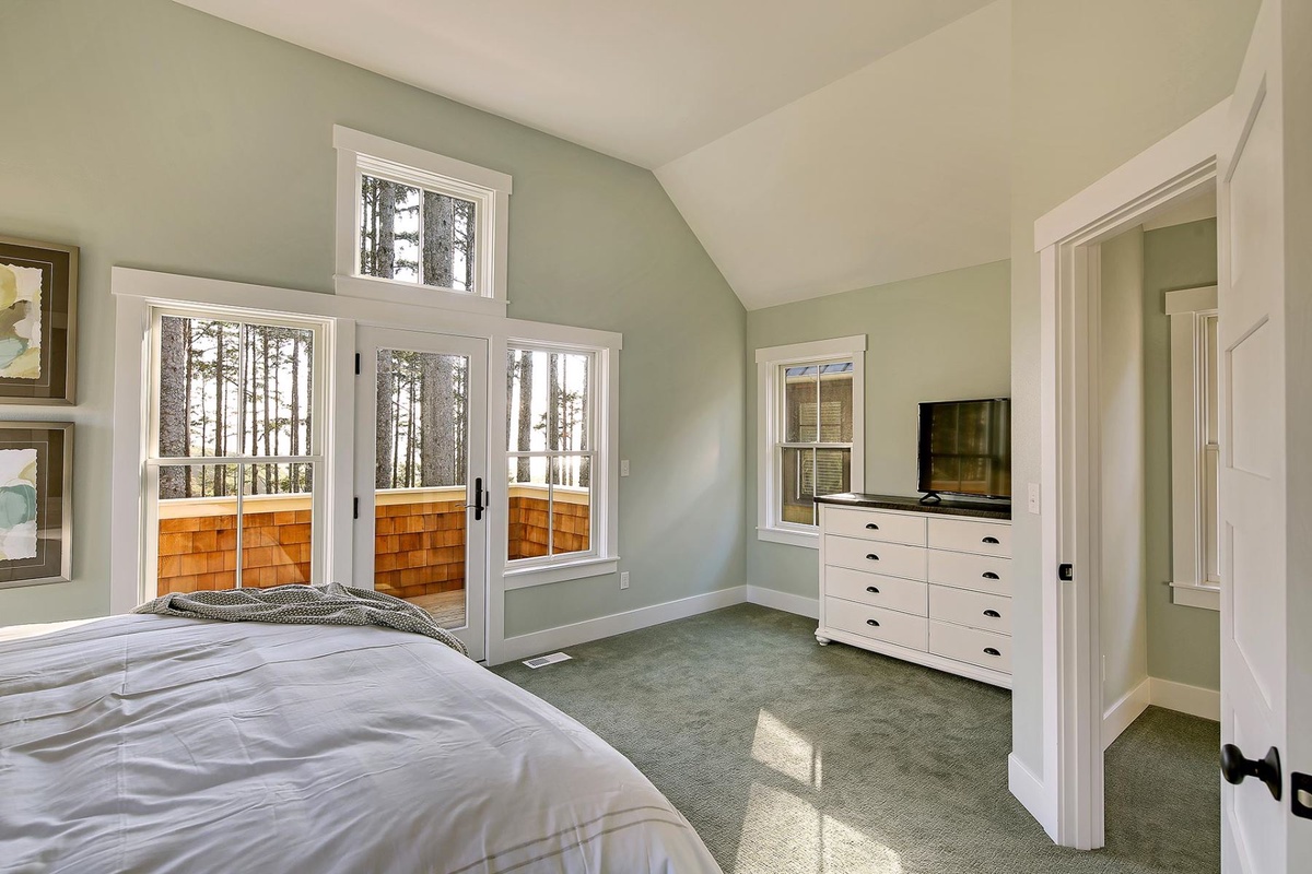 King primary bedroom with balcony