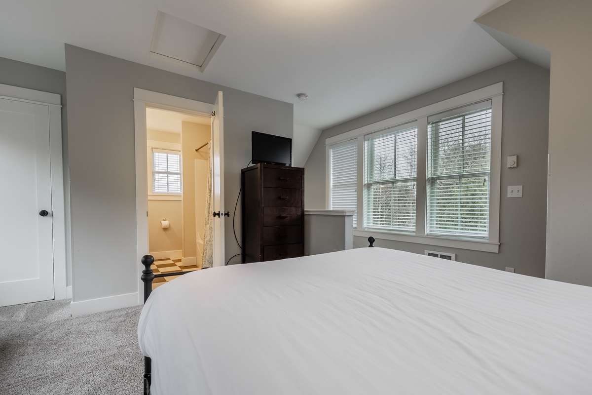 Primary bedroom with TV and ensuite bathroom