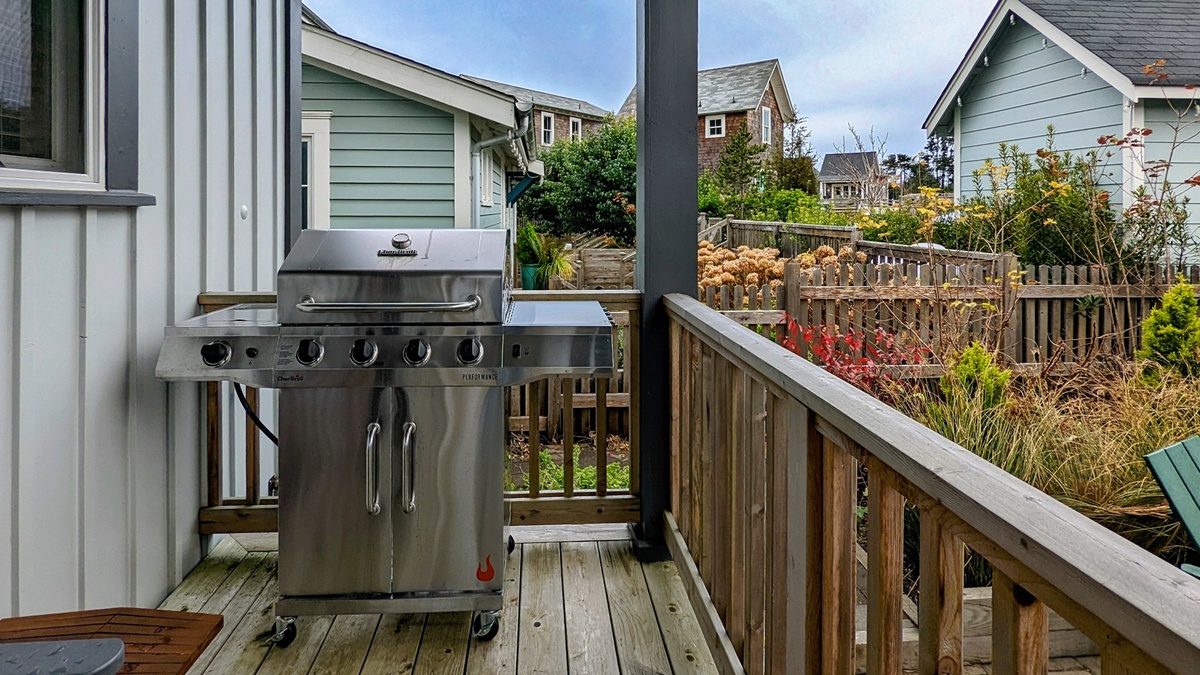 The covered back porch is equipped with a grill