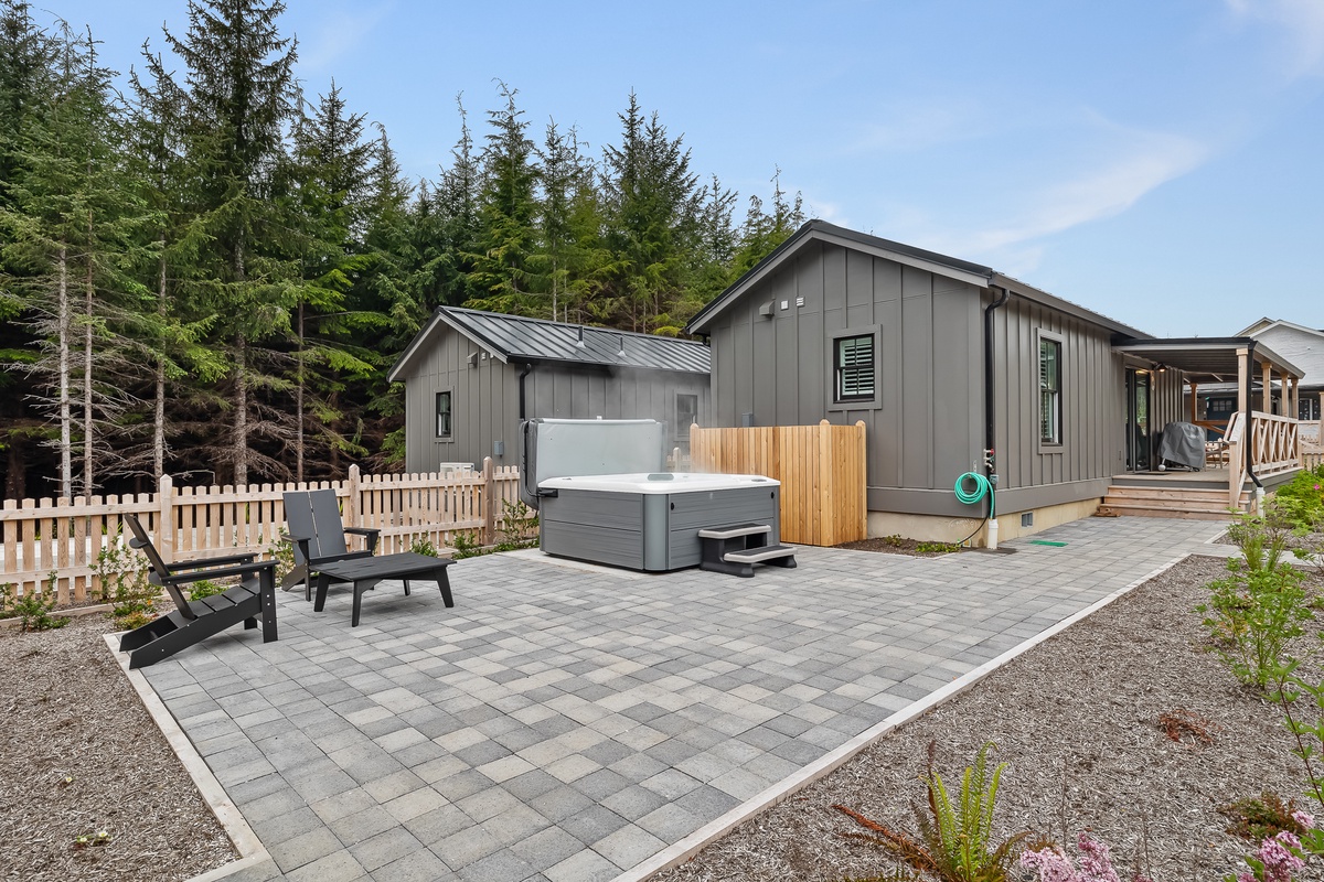 Spacious, full-fenced backyard with hot tub