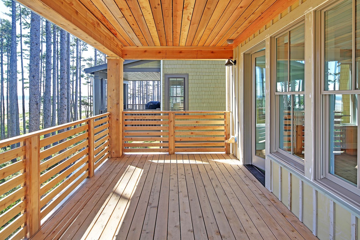 Covered deck with hot tub and ocean views