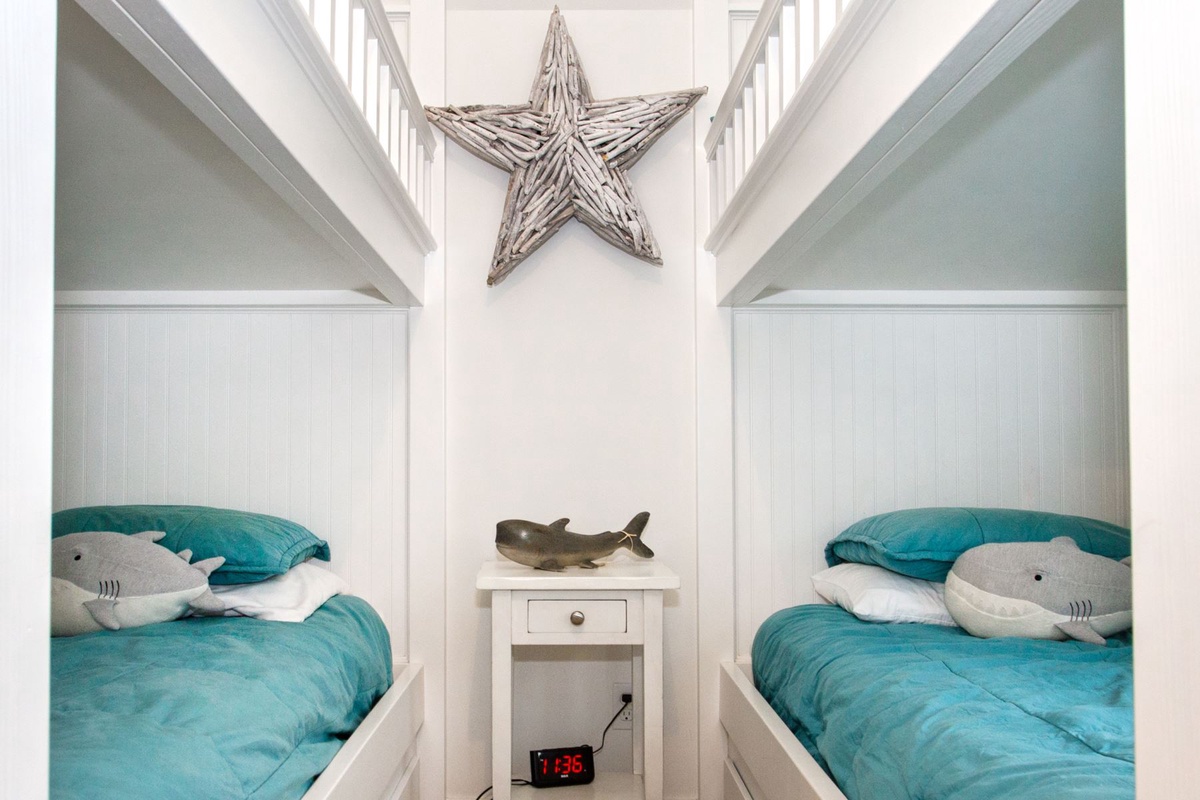 Night stand with alarm clock in bunk room