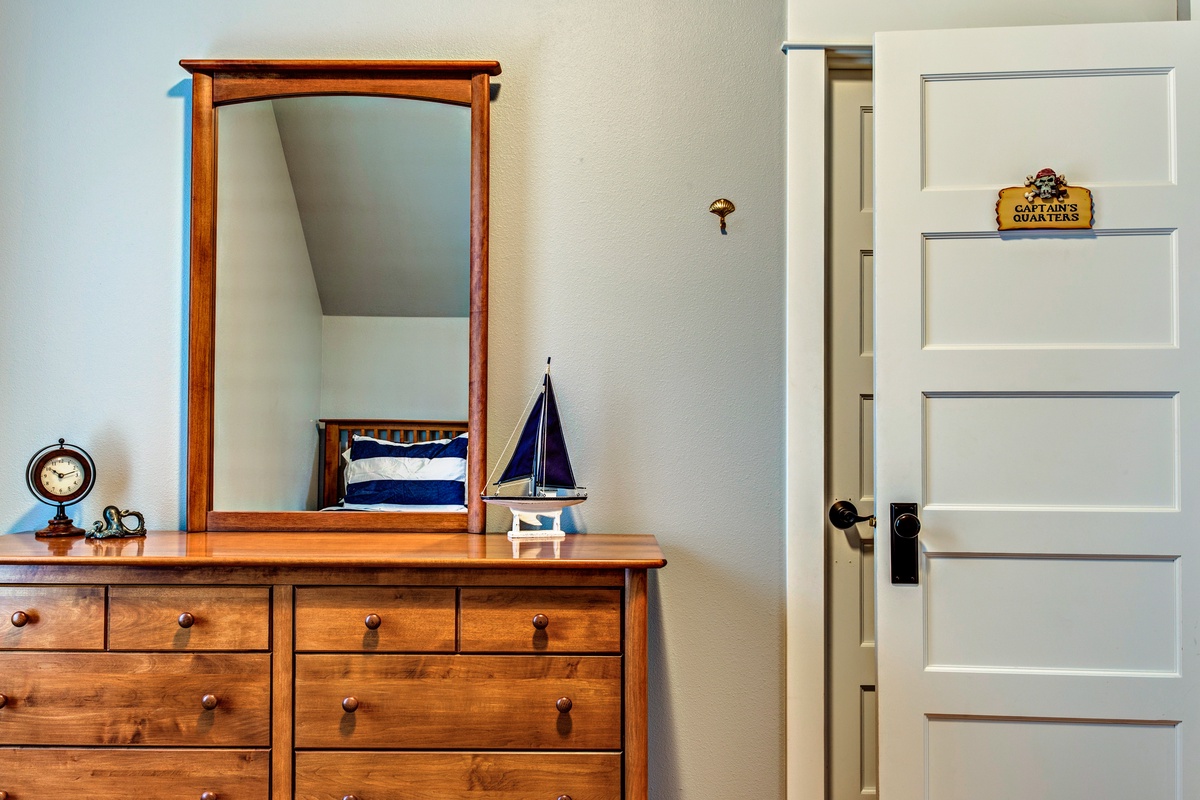 Dresser and doorway in second floor twin bedroom