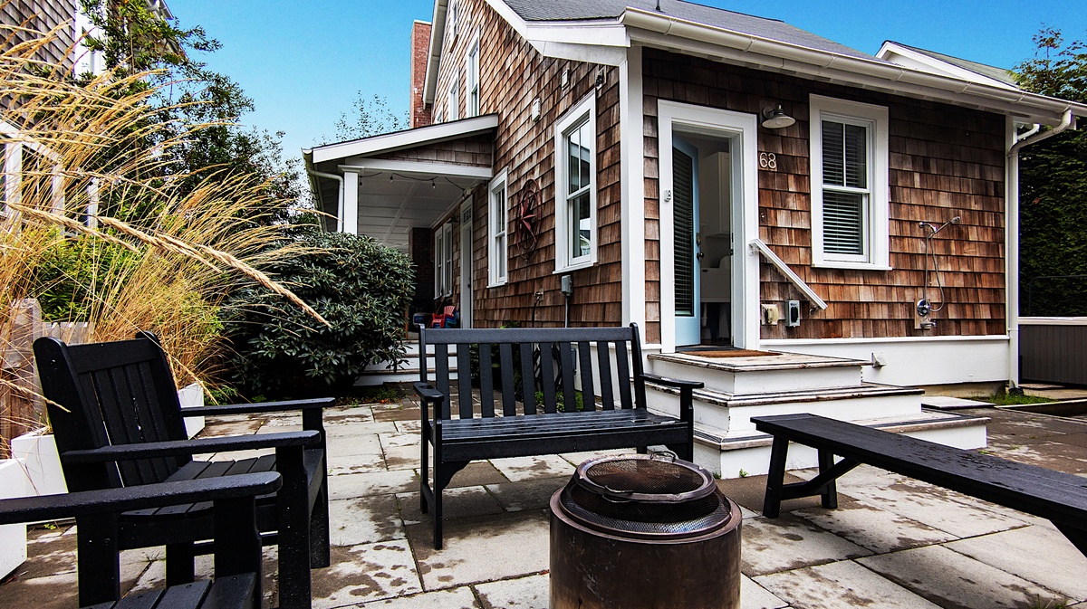 The back patio features a fire pit and seating