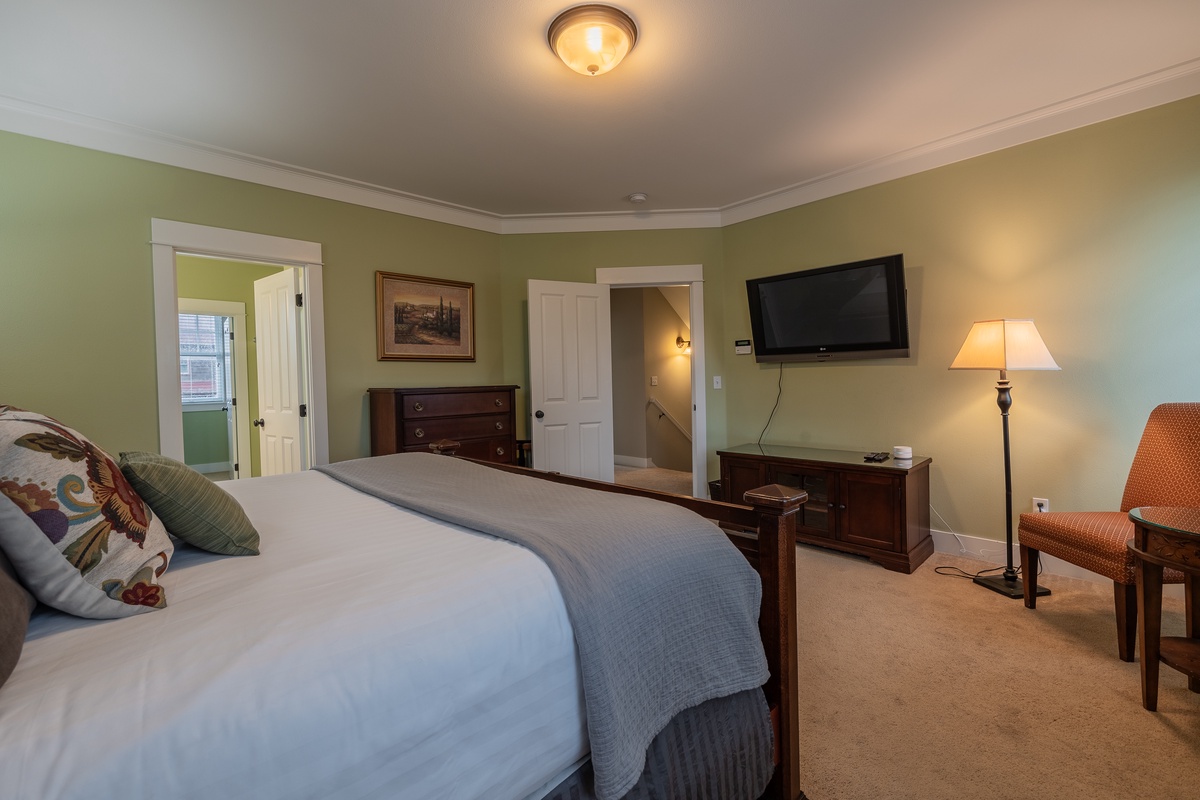 Primary bedroom with TV and ensuite bathroom