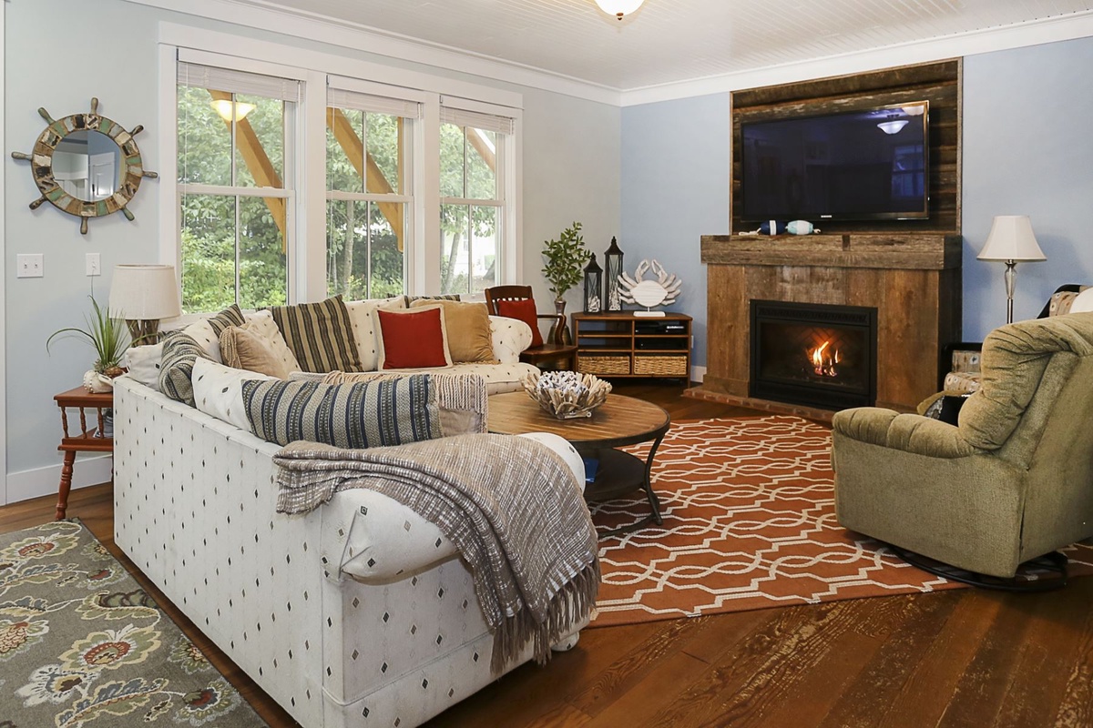Living space with gas fireplace and large smart TV