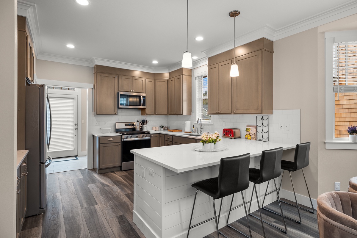 The kitchen counter has barstool seating