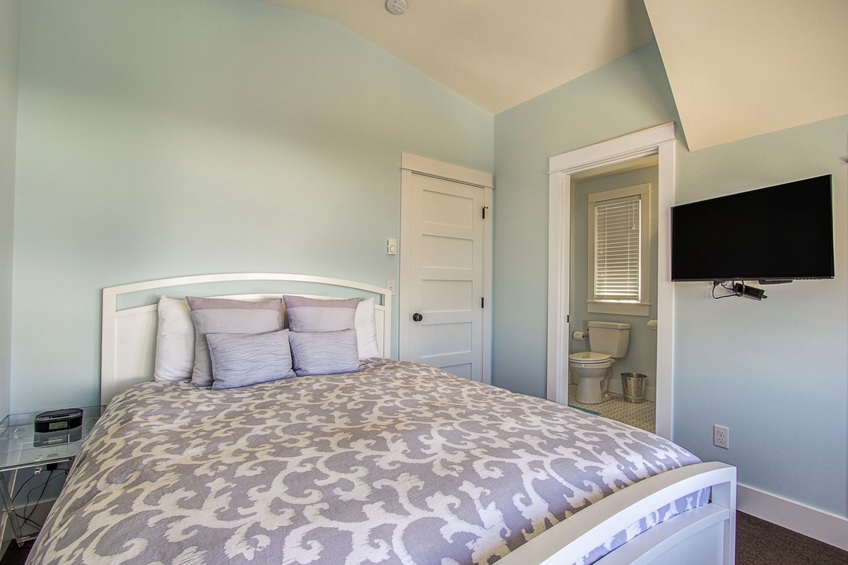 Third floor primary queen bedroom with private bathroom