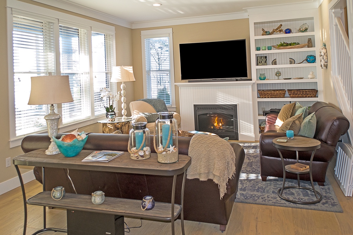 Living room with fireplace, tv, and ocean views