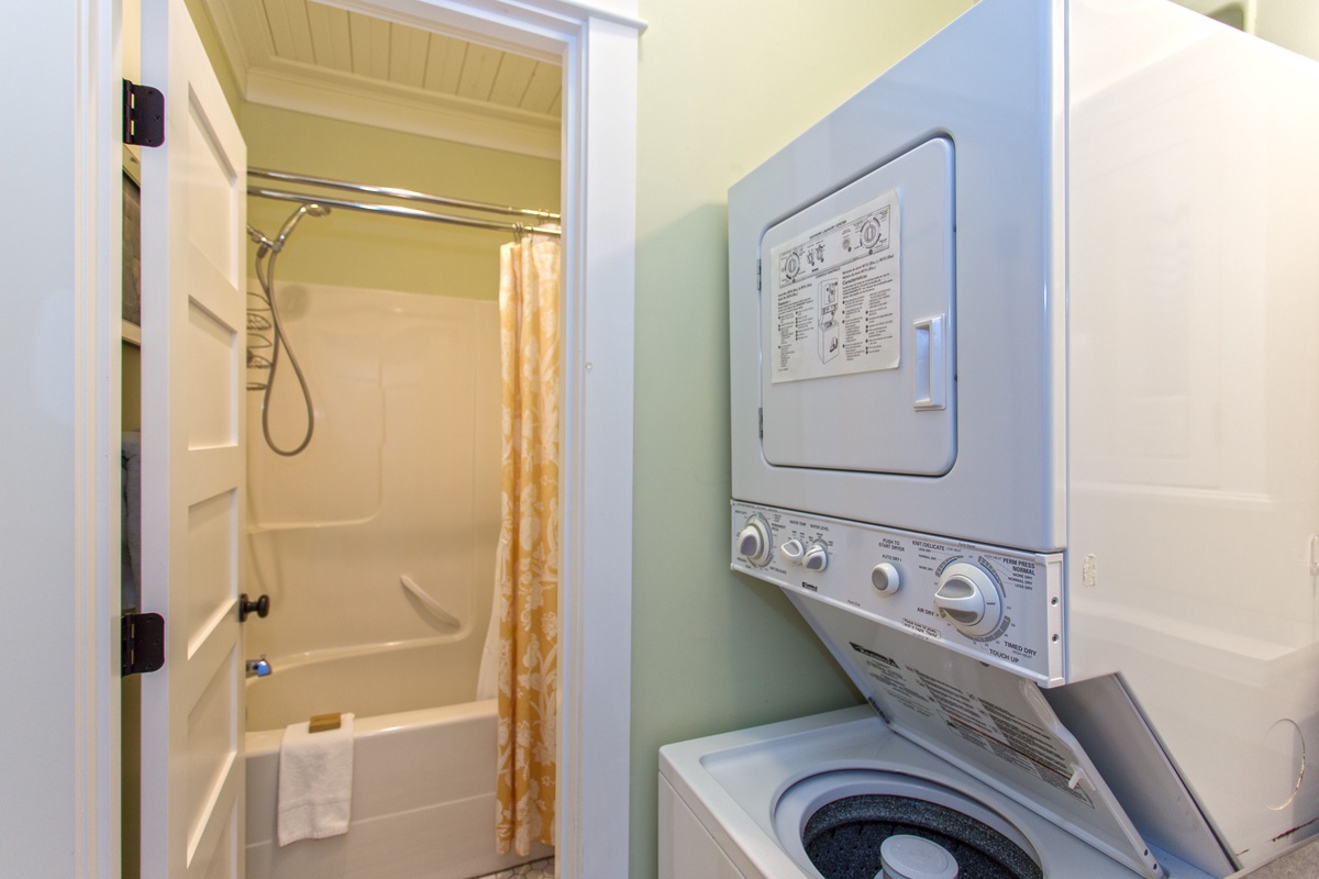 Washer and dryer next to bathroom