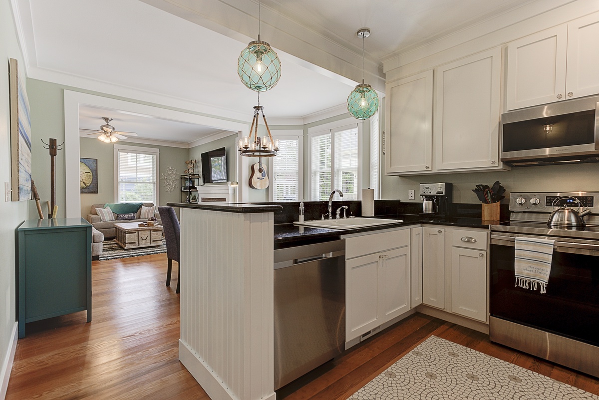 Spacious kitchen with new stainless steel appliances opens to the living and dining areas