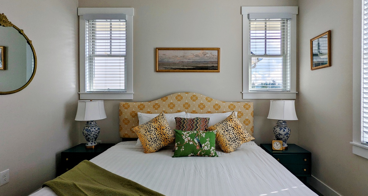 The bedroom has charming gold accents