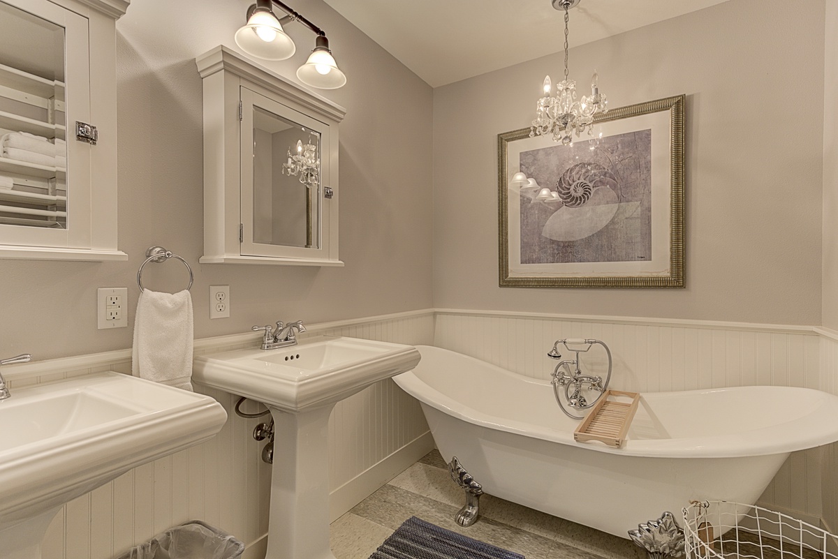 Private bathroom with his and hers vanity, large Clawfoot soaking tub and separate shower