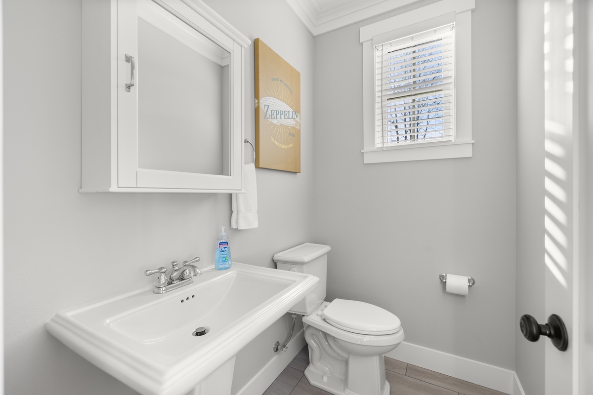 Main floor half bathroom is designed for refreshing