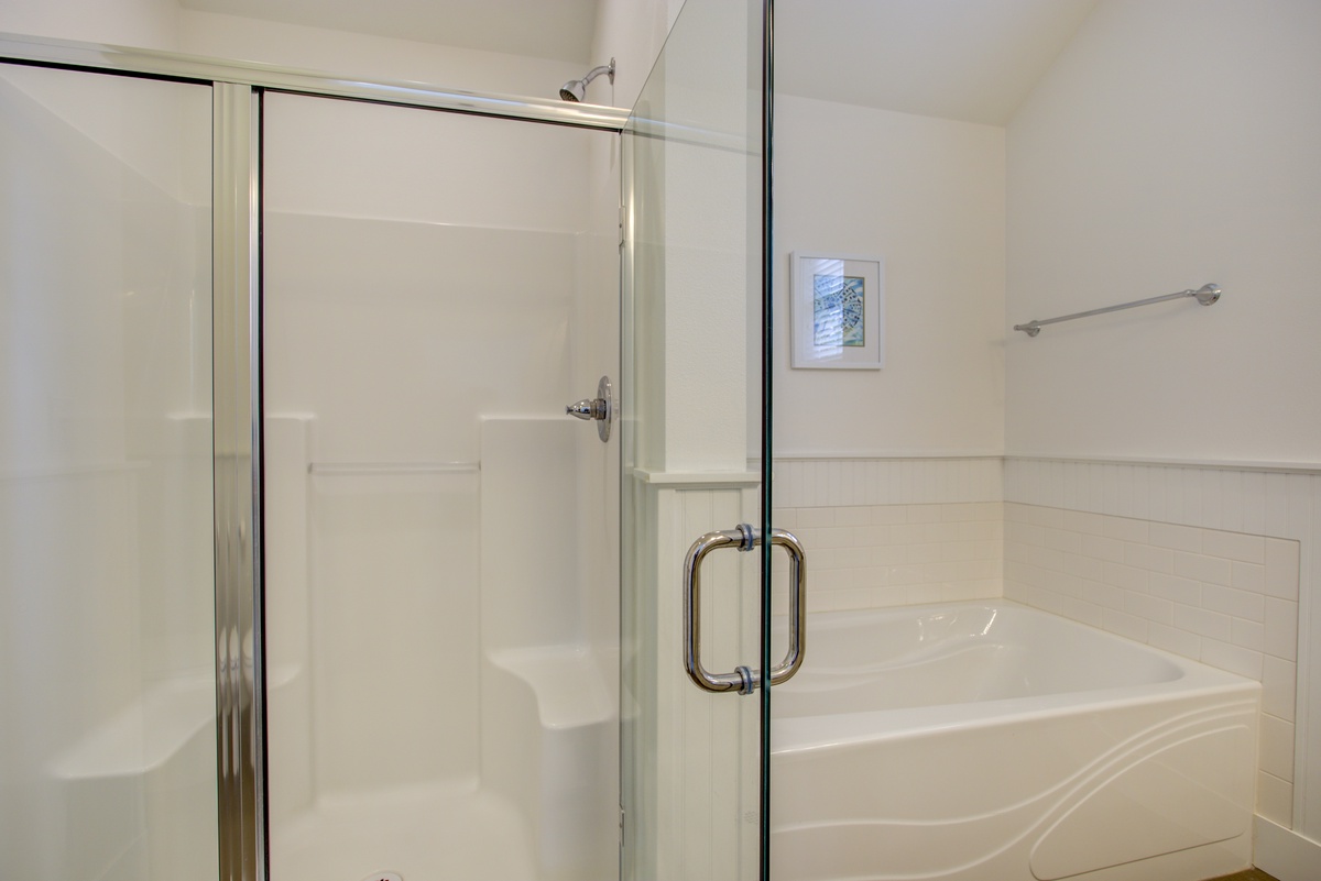 Primary ensuite bathroom with soaking tub and shower