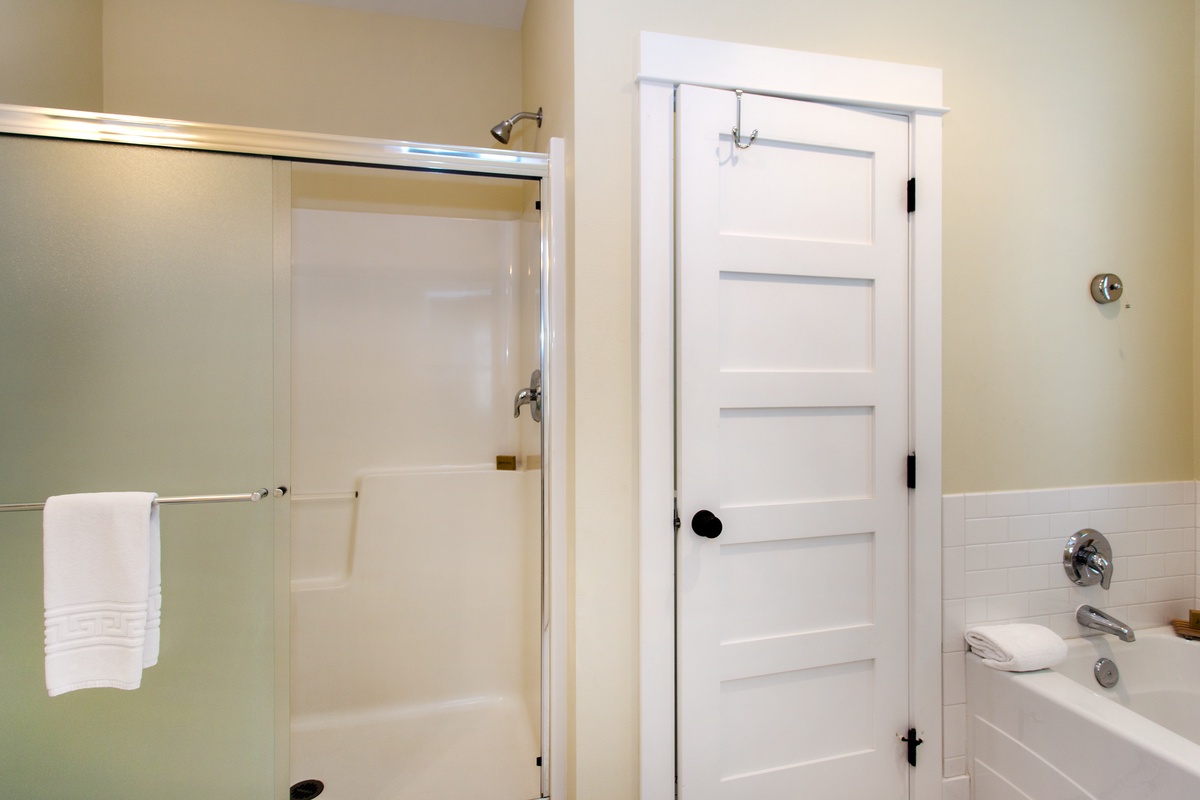 Primary ensuite bathroom with soaking tub and shower