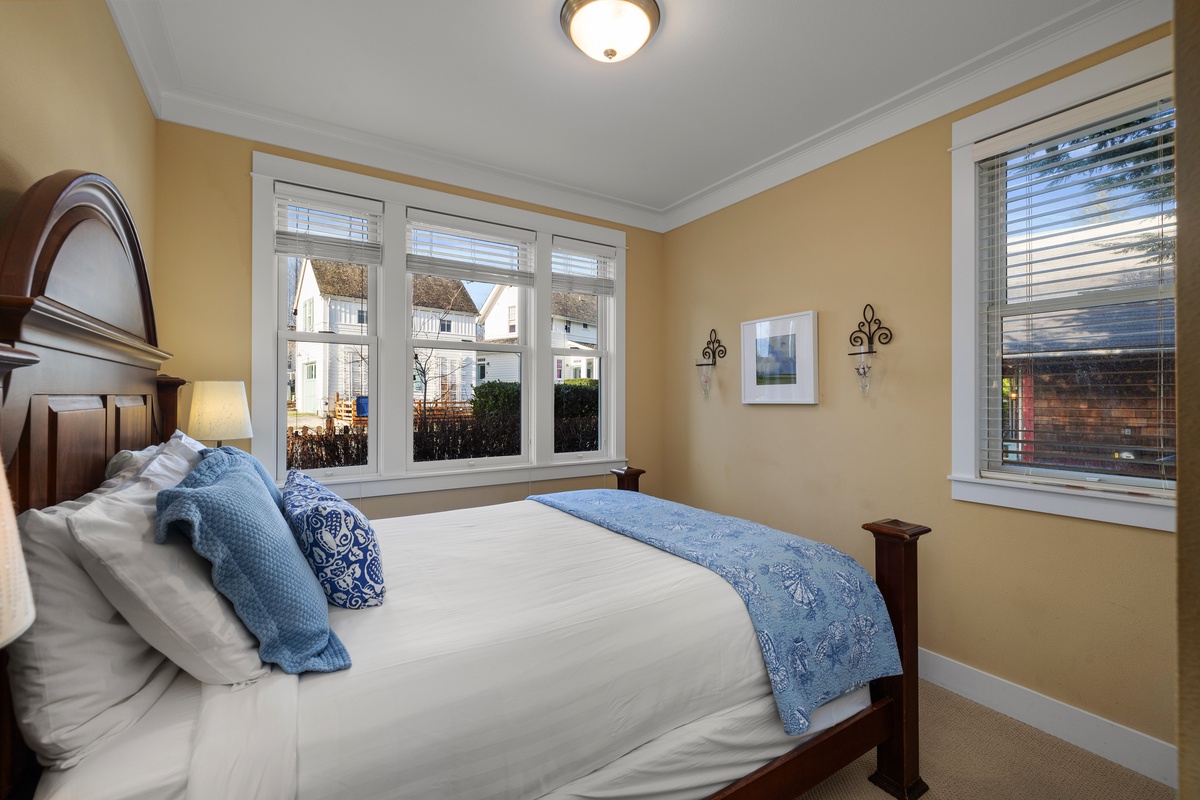 Peaceful queen bedroom with ample natural light