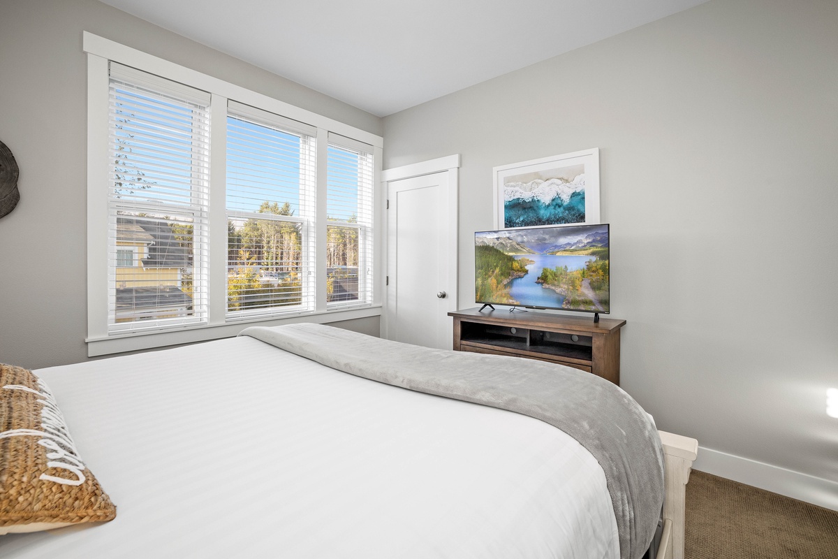 The primary bedroom has lots of natural light