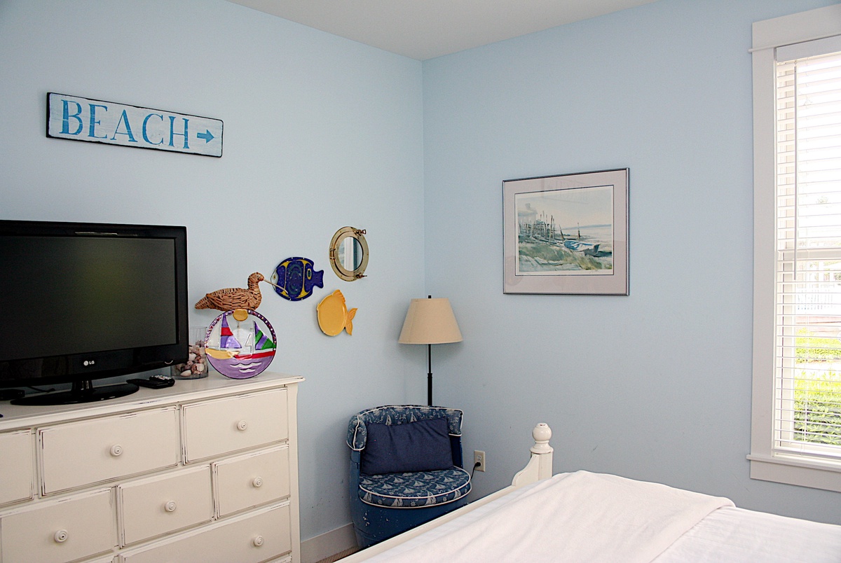 The primary bedroom has a flat screen TV