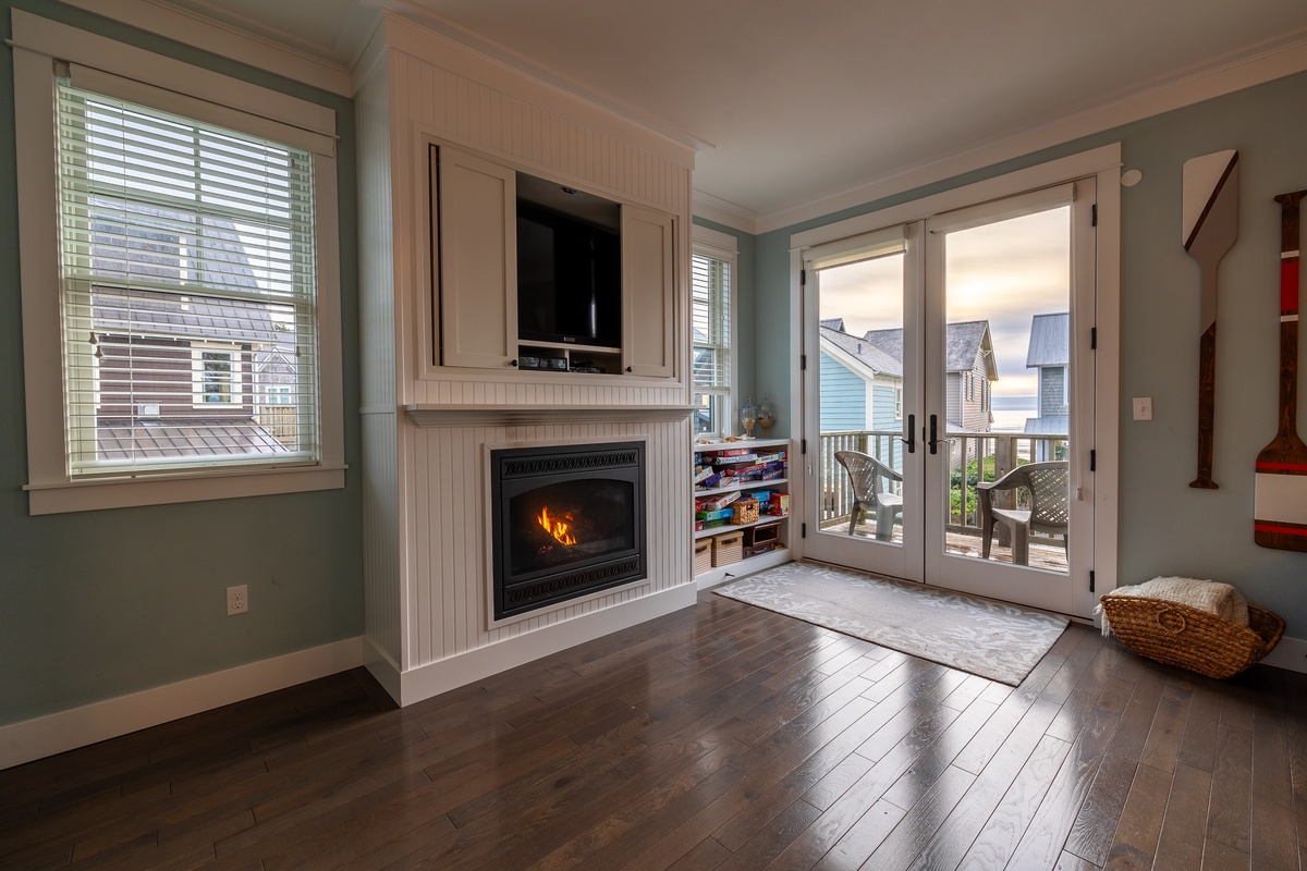 Living room with TV and fireplace