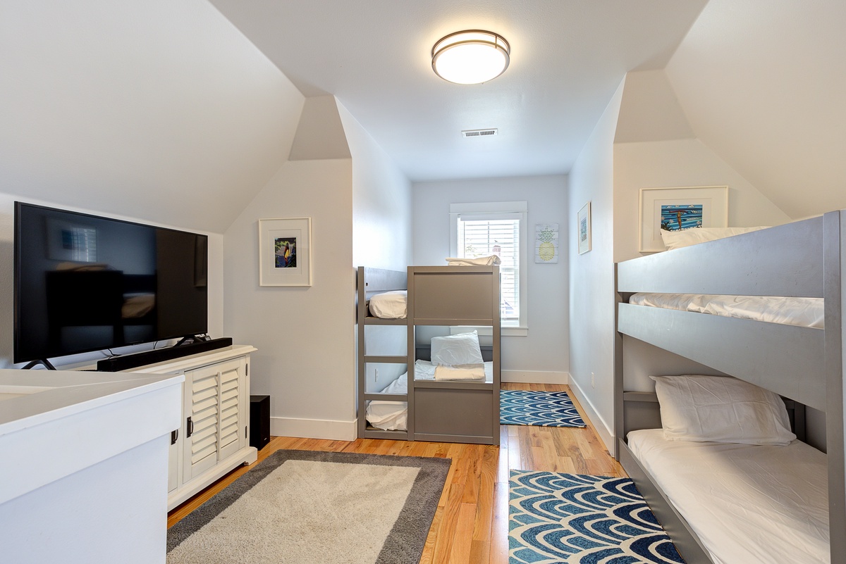 The bunk room features a TV for movie nights