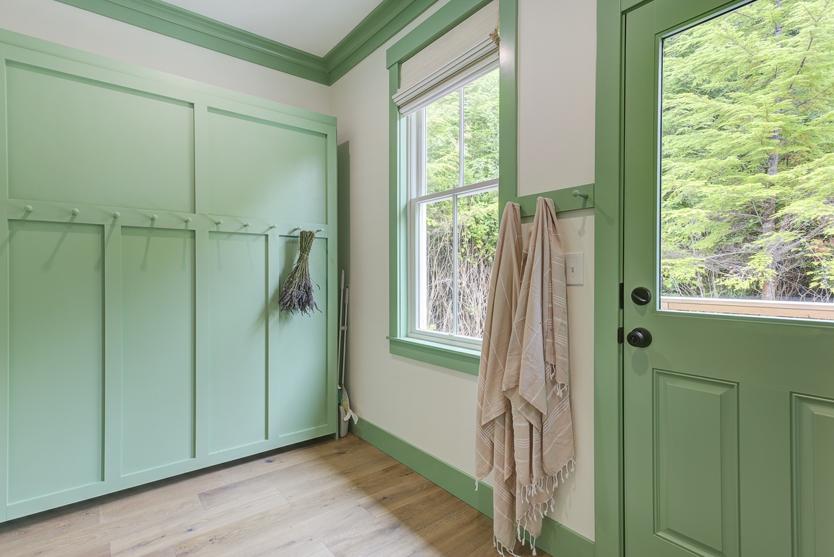 airy mudroom leads to the backyard