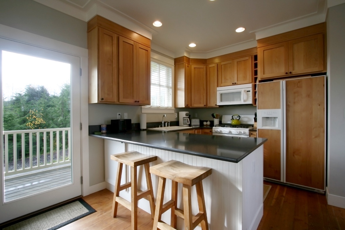 Fully stocked gourmet kitchen, door to covered deck