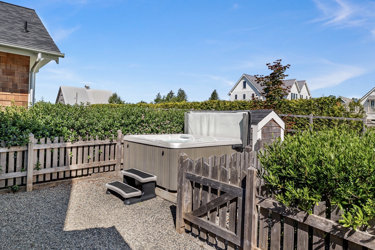 Private hot tub in the fully-fenced backyard