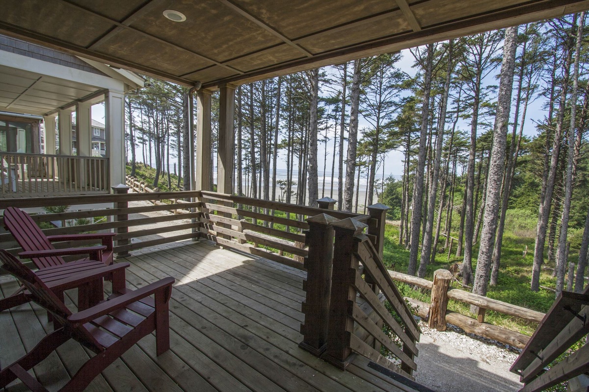 Covered front porch and stairs leading to the beach access trail
