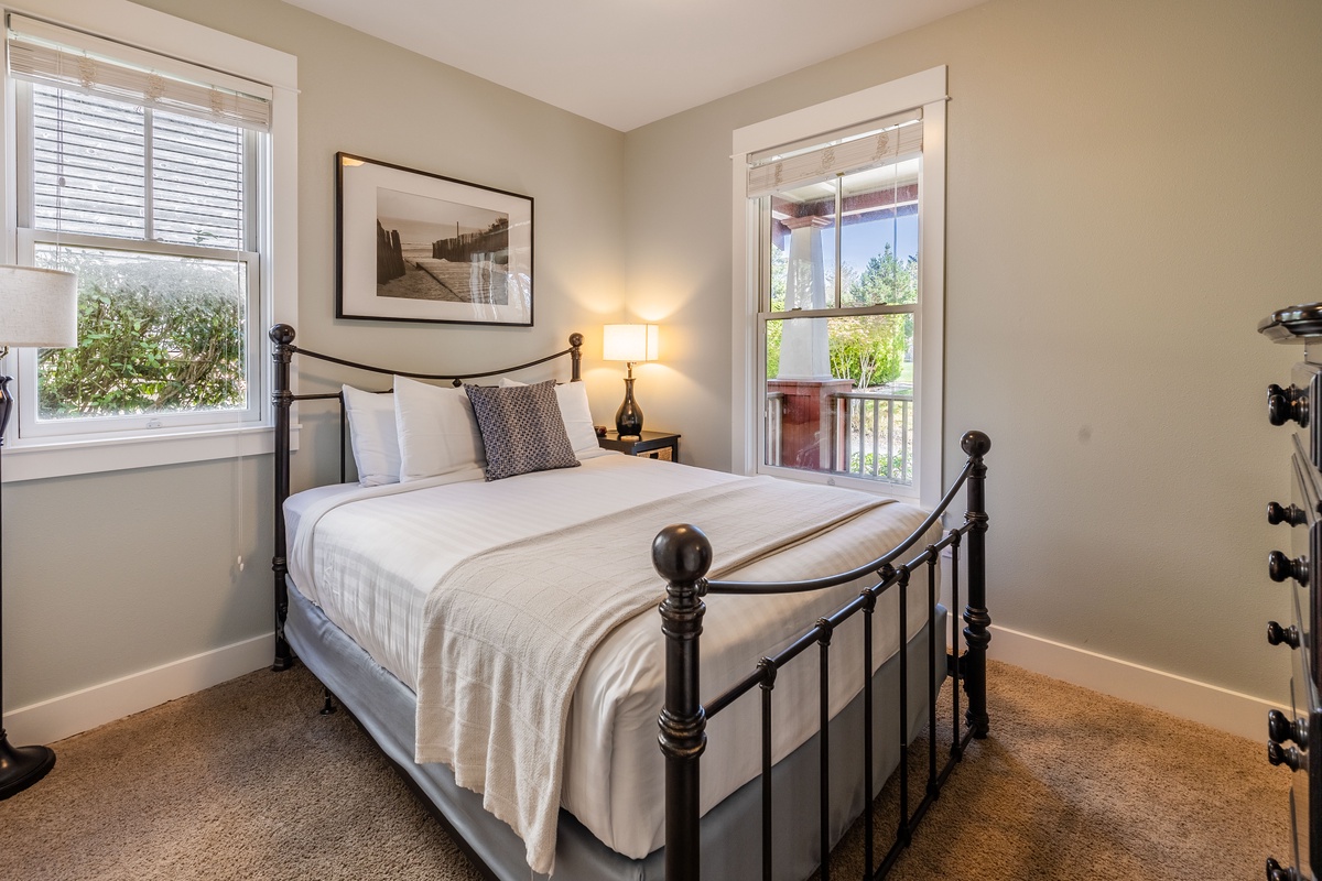 The main floor queen bedroom is designed for restful nights