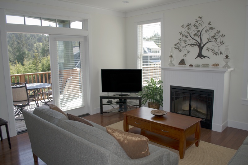 Living room with fireplace and flat screen TV, deck view